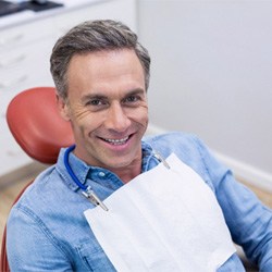 Senior male patient smiling after getting dental implants in Midwest City, OK