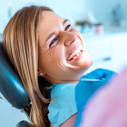 female dental patient smiling in chair