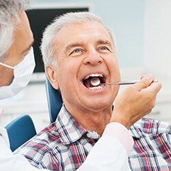 Male receiving a dental exam before restorative dentistry