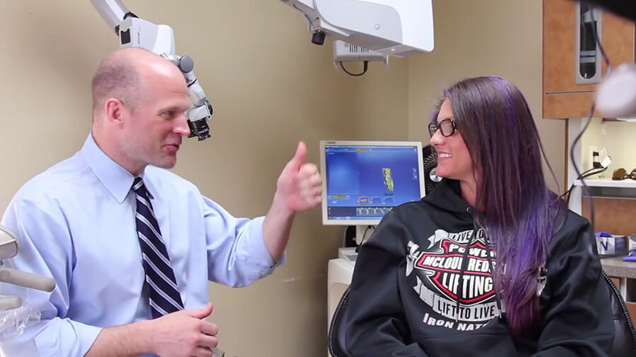 Midwest City dentist talking to patient in treatment chair