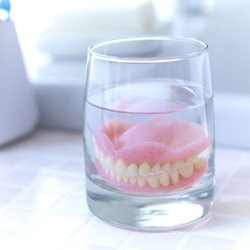 Dentures in Midwest City soaking in solution