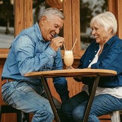 Senior couple with dentures in Midwest City sharing a milkshake