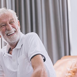 Older man smiling with dentures