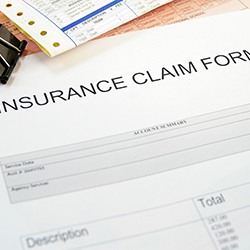 Insurance claim form on top of other documents