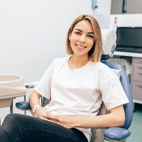 Woman smiling after receiving treatment for gum disease