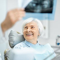 Senior woman visiting dentist for implant dentures in Midwest City, OK