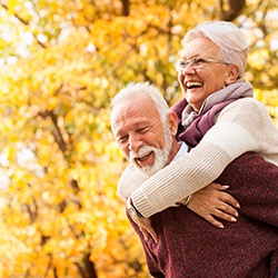 Senior couple outside with implant dentures in Midwest City, OK