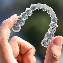 a person holding Invisalign aligner in Midwest City