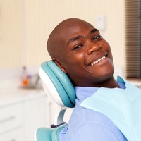 smiling patient who knows what to expect during an oral cancer screening in Midwest City