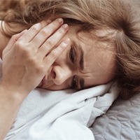 woman toothache in bed for root canal therapy in Midwest City 