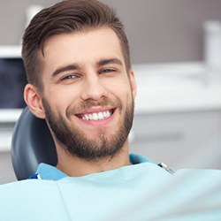 a patient smiling after paying the cost of teeth whitening