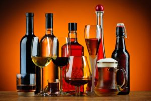 several alcoholic beverages sitting on a counter