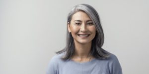 older happy woman with dental implants
