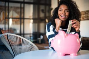 a woman with an enhanced smile while saving money 