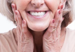 a woman smiling with healthy dentures
