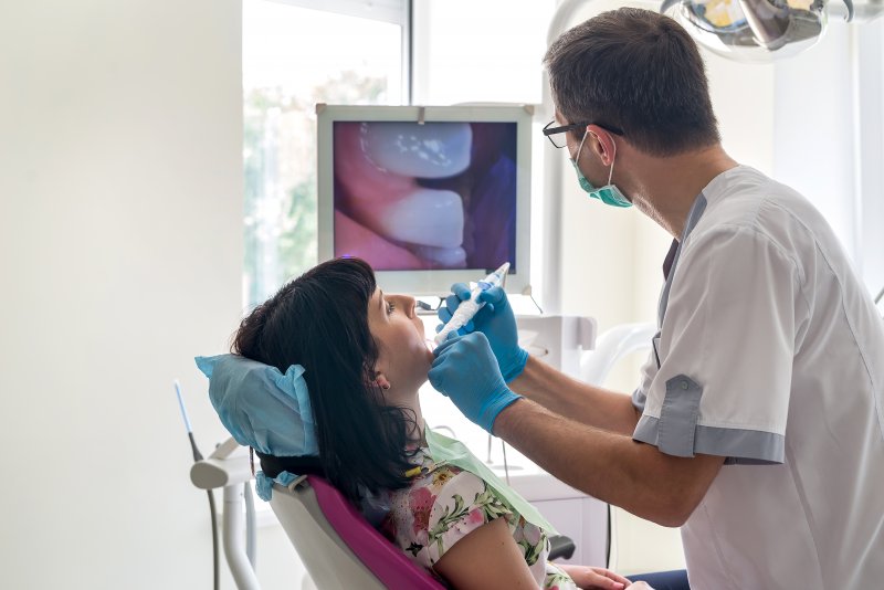 A dentist examining his patient during a cosmetic dentistry consultation