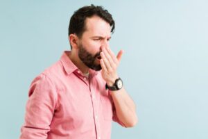 Man checking his breath.