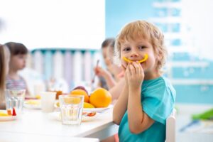 Child eating a bell pepper slice